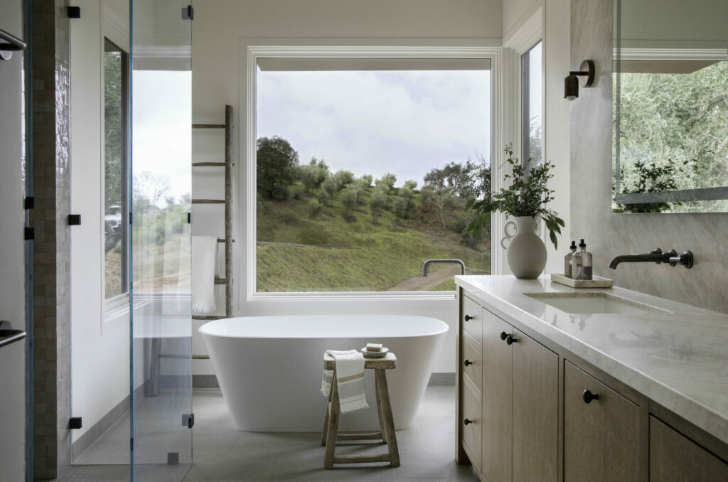 The newly built home of Steve Lacy and Debbie Thomas in Alexander Valley. In the primary bath, a soaking tub with a view of the olive grove. The primary bath is located in a space that bumps out from the main volume of the house. (Eileen Roche/Sonoma Magazine)