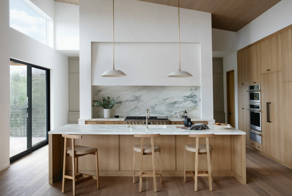 The newly built home of Steve Lacy and Debbie Thomas in Alexander Valley. Interior designer Emily Mughannam specified two complementary kitchen spaces on the main upper level of the home — a main kitchen, right, and a separate prep space and pantry tucked in behind. (Eileen Roche/Sonoma Magazine)