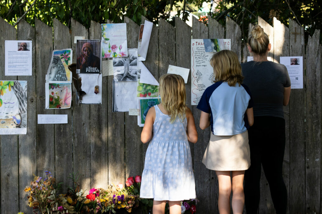 Kelsey Peters of Santa Rosa, right, with her two children, Maddy Iglehart, 10, and Izzy Iglehart, 8, all look at a memorial in honor of Ellynn Grace Cole, near the area where Grace once lived while she was homeless, in Steele Lane Park, Santa Rosa, Thursday, Aug. 1, 2024. Ellynn Grace Cole died in Steele Lane Park on June 26, 2024. (Darryl Bush / For The Press Democrat)