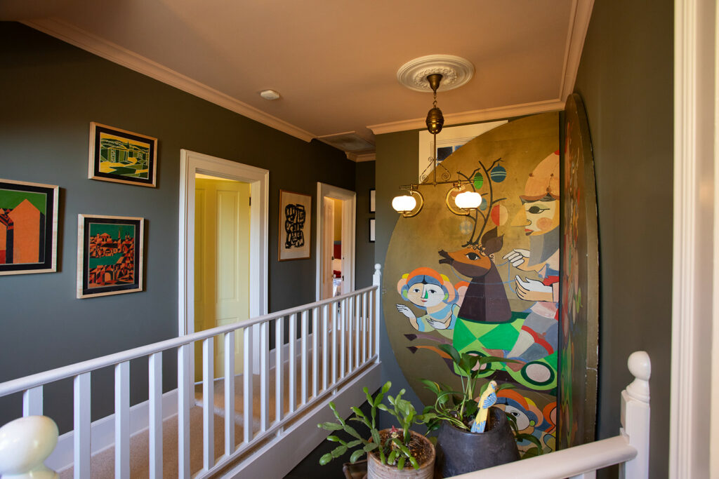 Though each room of the home has a different color palette, the tones echo throughout the space, from the downstairs bath to the upstairs hallway (pictured). (Eileen Roche)