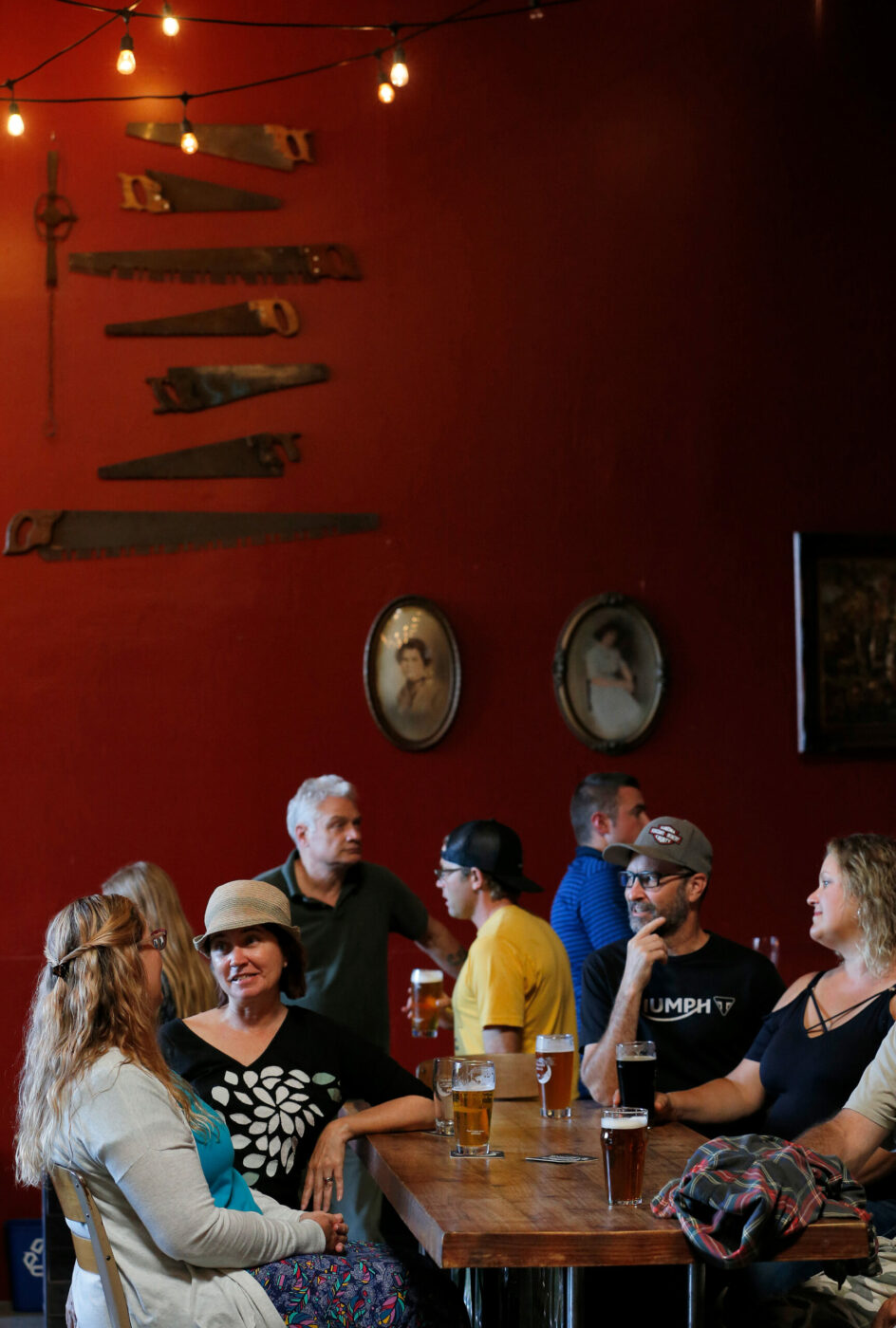 Customers enjoy craft brews, conversation and live music at Moonlight Brewing Company in Santa Rosa on Thursday, July 18, 2019. (Alvin Jornada / The Press Democrat)