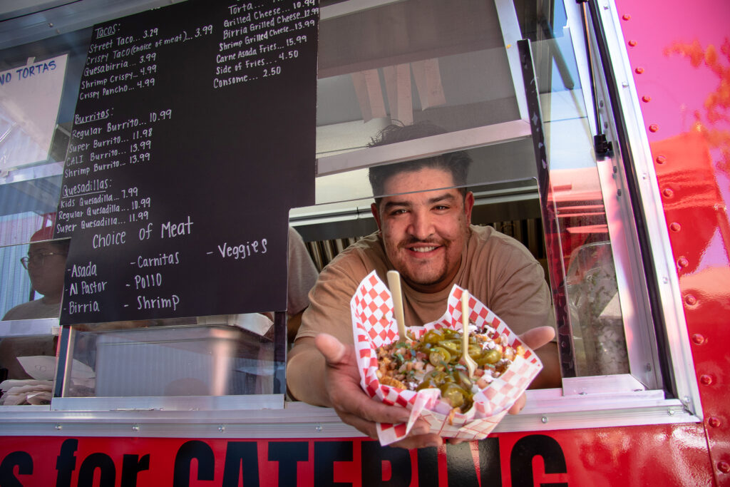 Omar Galvan delivers an order from the pickup window at Galvan’s Eatery in Santa Rosa. (Heather Irwin / The Press Democrat)