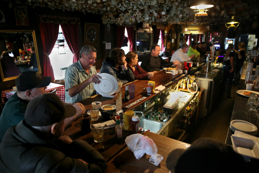 Patrons sit at the bar at Washoe House in Petaluma on Wednesday, November 21, 2018. (Beth Schlanker / The Press Democrat)