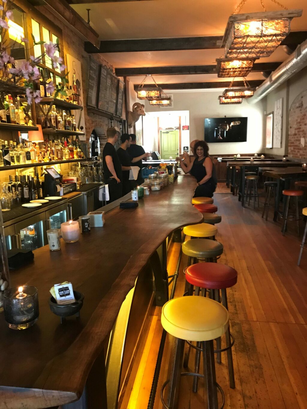 People mill around the bar at the Geyserville Gun Club and Lounge in the Odd Fellows Building. (The Press Democrat)