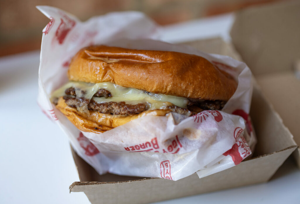 Iggy’s Organic Burgers with duck fat and beef patty, buttery brioche, organic American cheese, ketchup, mustard, onions caramelized with a secret sauce, and pickles are served on the plaza, Friday in Downtown Healdsburg June 30, 2023. (Chad Surmick / The Press Democrat)