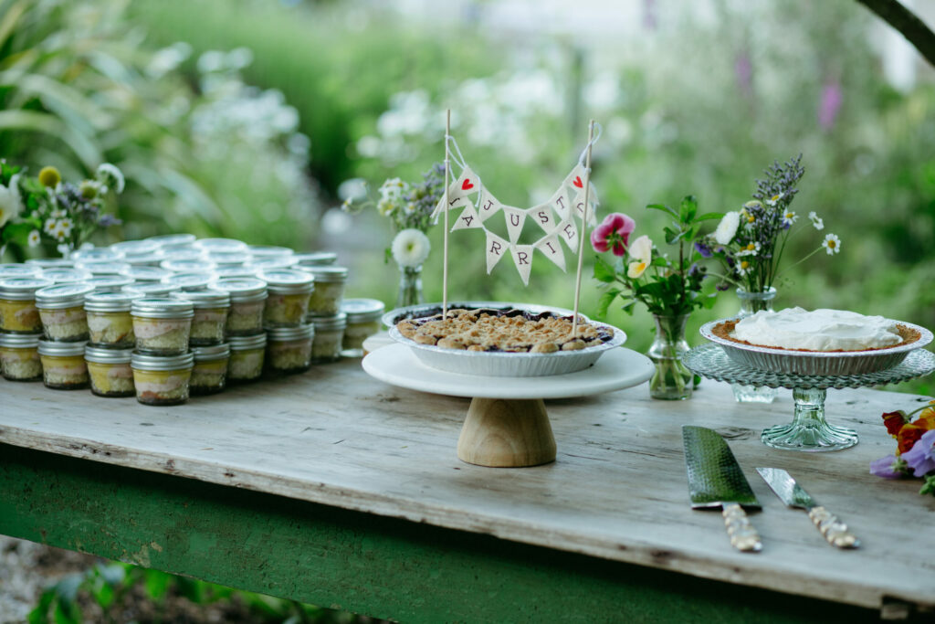 Instead of a traditional tiered cake, the couple opted for seasonal fruit pies as well as cake jars decorated with stickers of their dog, Odin. (Stephanie Klotz)