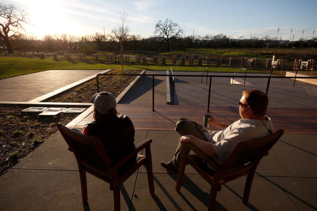 Amy and Nathan Booth enjoy drinks while taking in the sunset on the patio at Russian River Brewing Company in Windsor. (Alvin Jornada/The Press Democrat)