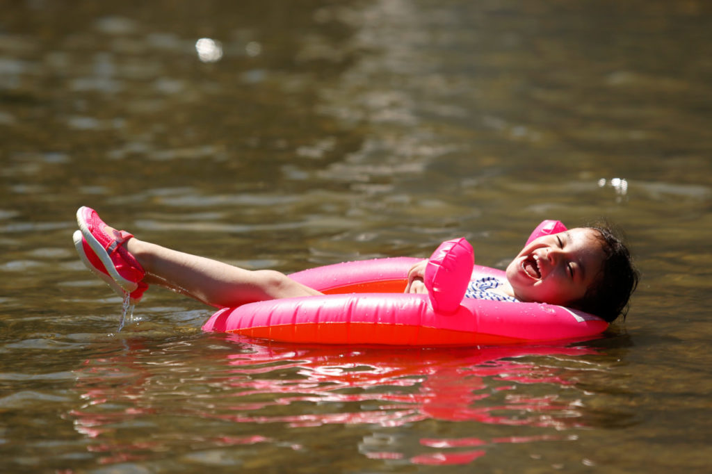 Tamara Bautista, 3, laughs as she floats in the water at Veterans Memorial Beach in Healdsburg, California on Saturday, June 18, 2016. (Alvin Jornada / The Press Democrat)
