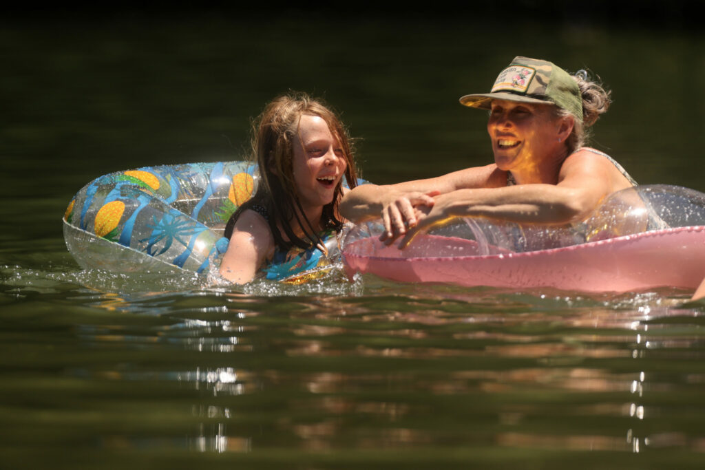 Mina Housh, 8, and her mother Nicole swim at Johnson's Beach in Guerneville, Calif. on Tuesday, June 21, 2022. (Beth Schlanker/The Press Democrat)