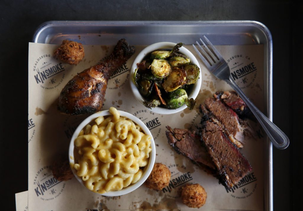 Barbecue chicken, brisket, Brussels sprouts with bacon, macaroni and cheese, and hush puppies at Kinsmoke in Healdsburg. (Beth Schlanker/The Press Democrat)