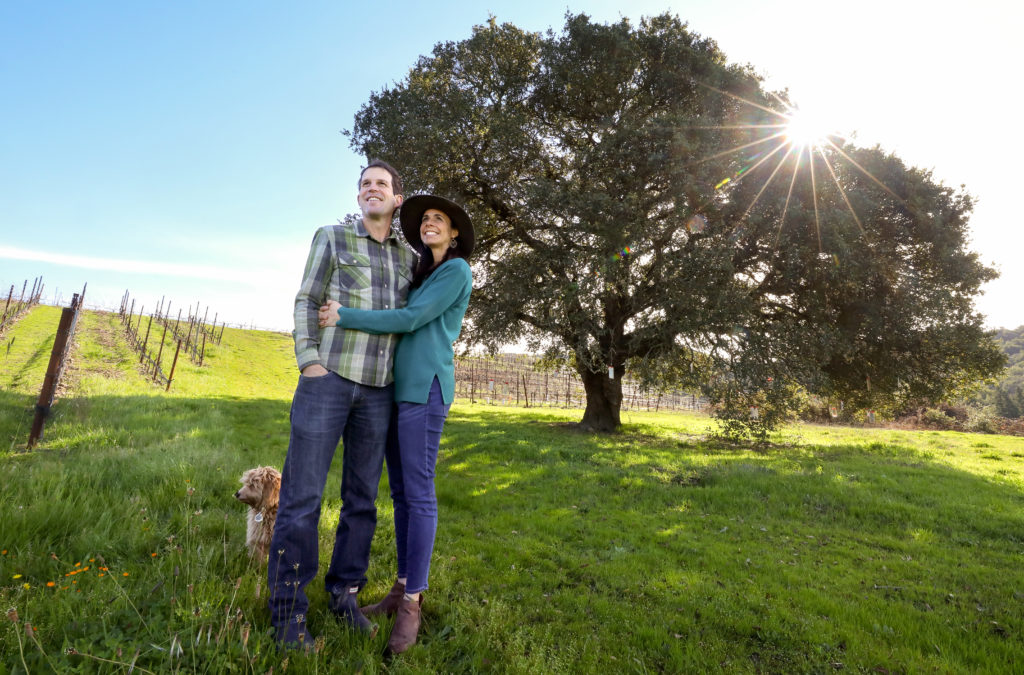 Nate and Lauren Belden, and their dog Penny, at the Wishing Tree on their Belden Barns property, on the northwest shoulder of Sonoma Mountain, near Santa Rosa. (Christopher Chung/The Press Democrat)