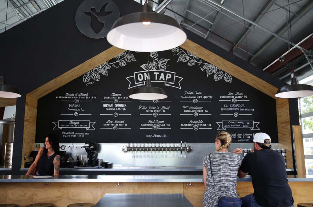 The beer menu is written on a large chalkboard behind the bar at Crooked Goat Brewing, in Sebastopol, on Wednesday, October 12, 2016. (Christopher Chung/ The Press Democrat)