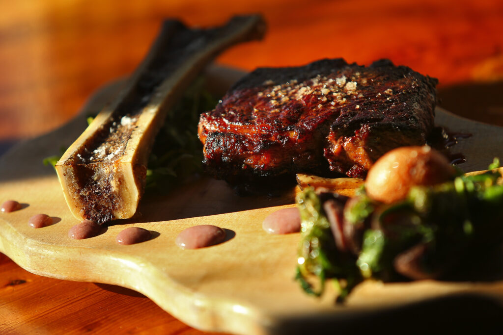 Peppercorn crusted New York steak with wild mushroom fondue, and roasted bone marrow, served with potato and pepper hash, by chef Dustin Valette at Valette, in Healdsburg. (Christopher Chung/ The Press Democrat)