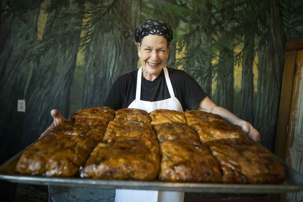 Krikit Morris has been making sticky buns and bread for 17 years at Wild Flour Bread in Freestone. (John Burgess/The Press Democrat)
