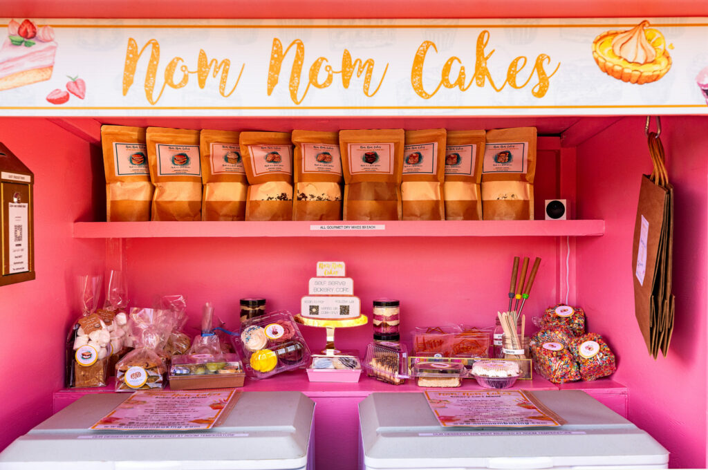 Baker Lana Mcintire rolls out her Barbie pink Nom Nom bakery cart filled with goodies in front of her Carmet home, just follow the signs off Highway 1. Friday, May 13, 2025, north of Bodega Bay. (John Burgess / The Press Democrat)