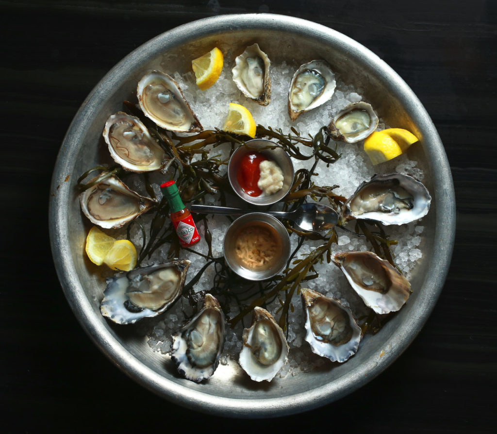 The Dozen Oyster plate includes St. Simone, Kummomoto and Hog Island oysters from The Shuckery in Petaluma. (John Burgess/The Press Democrat)