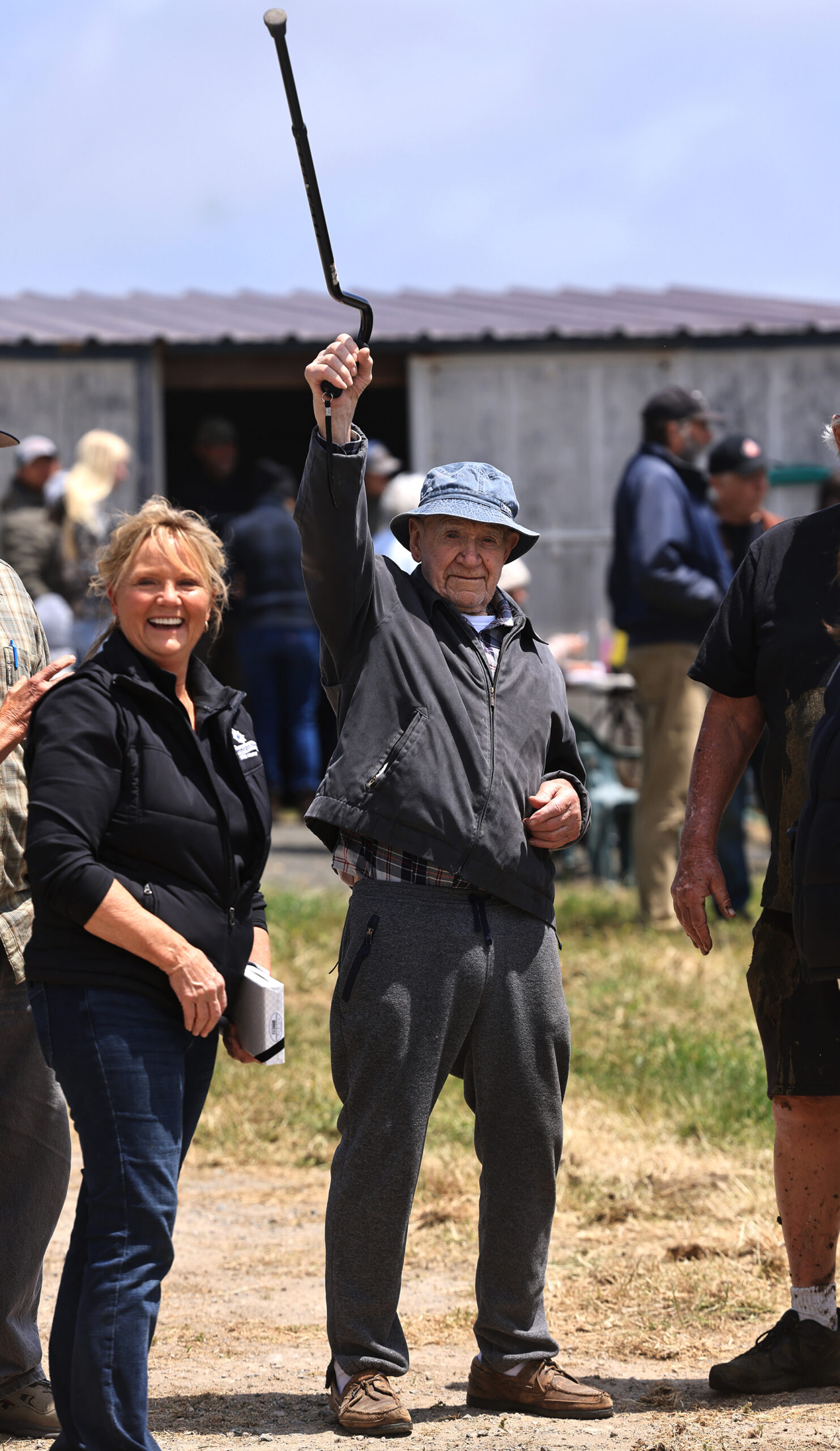 With daughter Ginny Cummings, Joe Lunny waves to family as they arrive for the family’s last cattle roundup, Saturday, May 17, 2025. (Kent Porter / The Press Democrat)