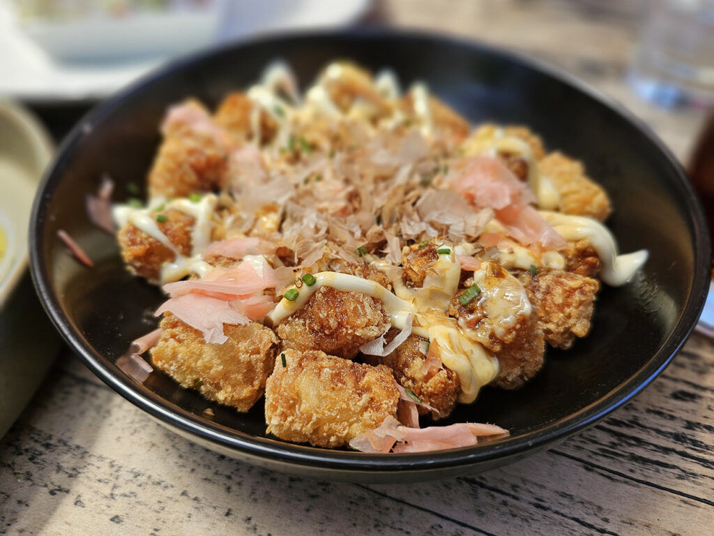 Healdsburg Bar & Grill's okonomiyaki tots come with a sweet-salty uangi sauce, Kewpie mayo, chives and bonito flakes. (Heather Irwin/Sonoma Magazine)