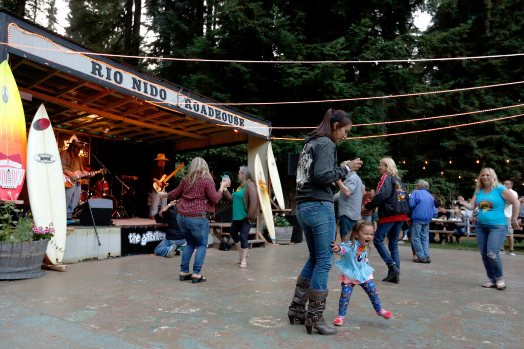 Keira Santamarina, 2, dances with her mother Rebecca Santamarina of Petaluma during the Rio Nido Roadhouse Surf Music Fest in Rio Nido on Saturday, July 16, 2016. (Alvin Jornada / The Press Democrat)