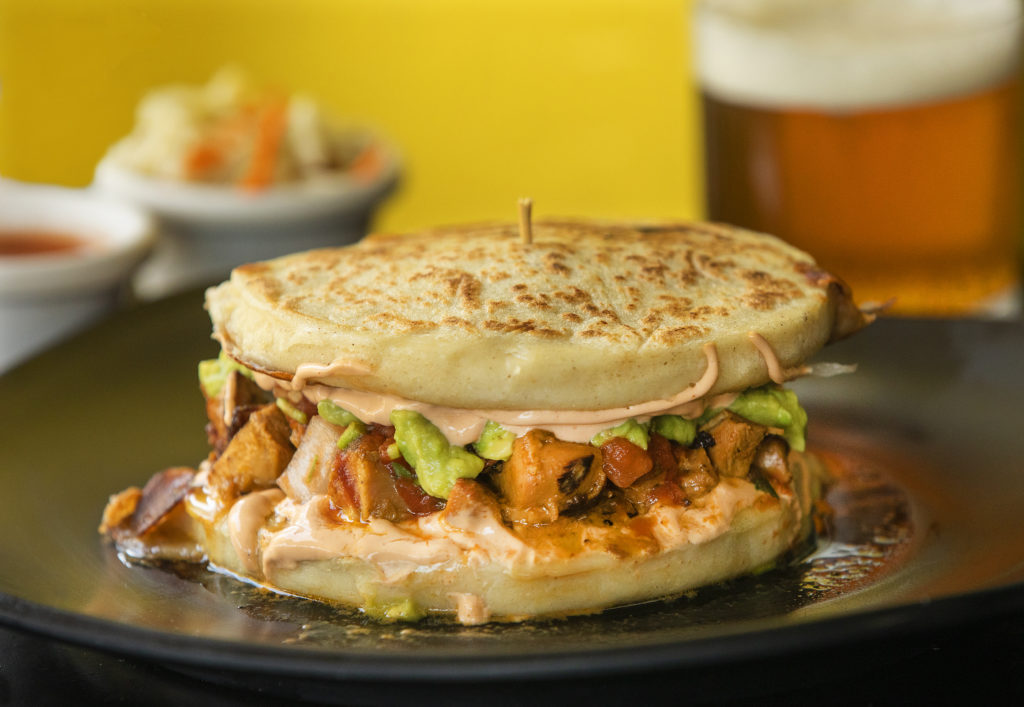Orange Marinated Chicken Pupusa Burger with choice of two stuffed pupusa's filled with pico de gallo, guacamole, lettuce, cheese and chipotle cream from Don Julio's Latin Grill & Pupusas in Rohnert Park. (John Burgess / The Press Democrat)