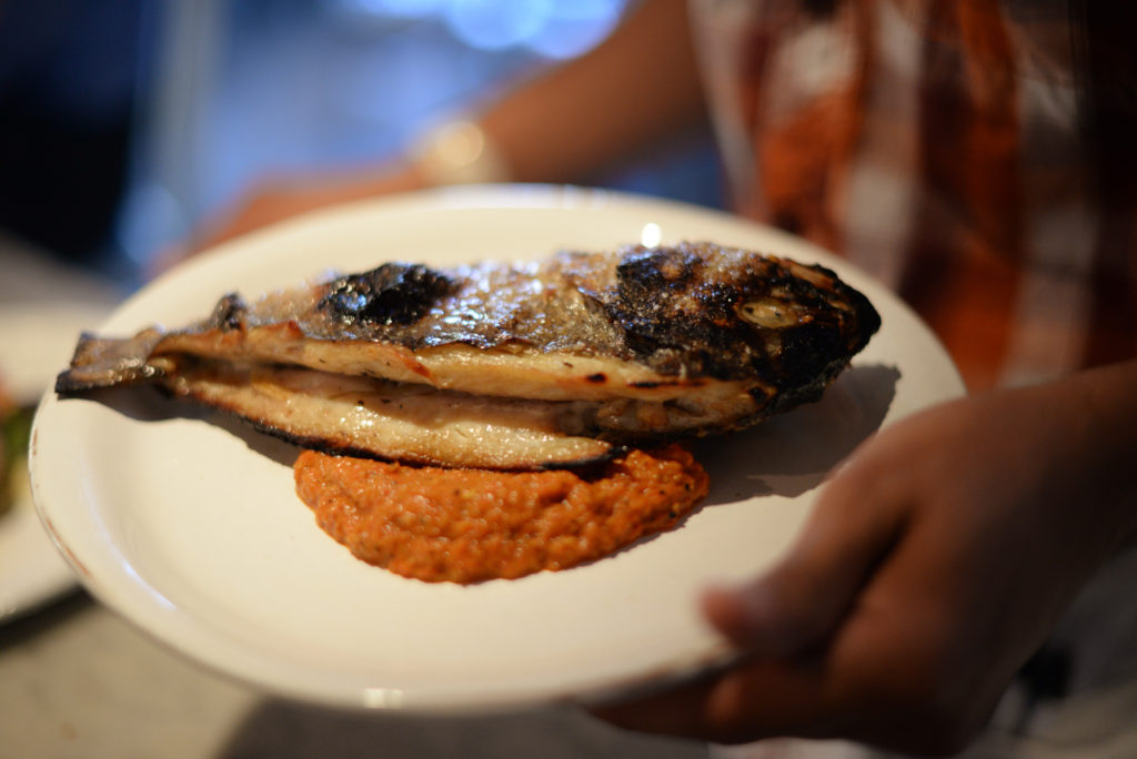 The Glen Ellen Star, in Glen Ellen, uses their wood fired oven for a variety of menu items including this whole fish served over a romesco sauce. September 8, 2014 (Photo: Erik Castro/for The Press Democrat)